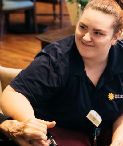 Sunny Vista Senior Living Community in Colorado Springs, CO - the retreat team member with resident landscape