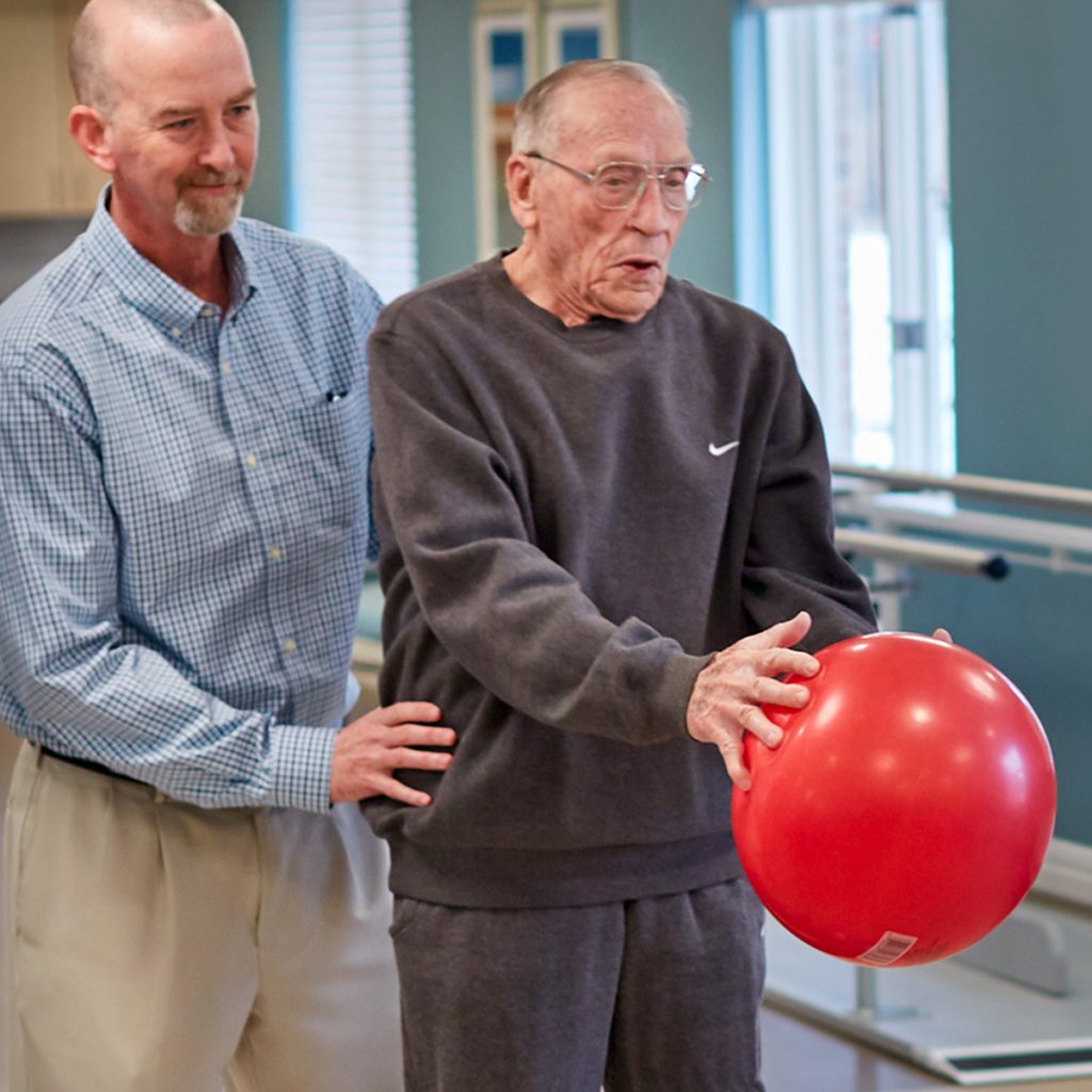 Sunny Vista Senior Living Community in Colorado Springs, CO - sunny vista senior man and caregiver in rehabilitation